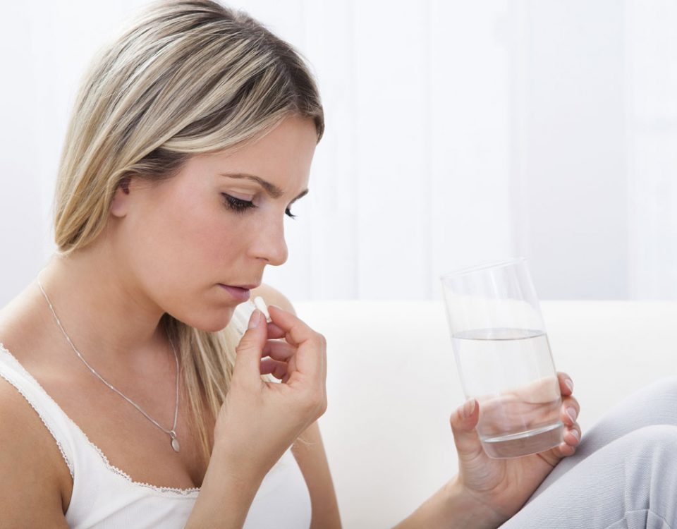 woman drinking pill